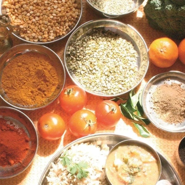 Fresh food ingredients like tomatoes, lentils, spices and herbs