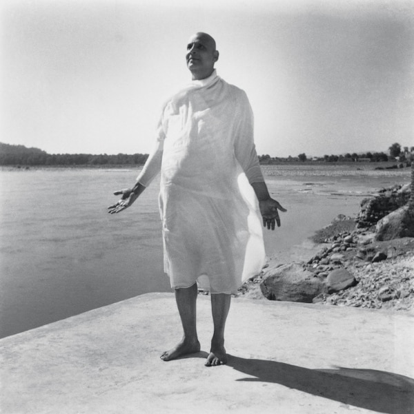 Swami Sivananda with palms outstretched