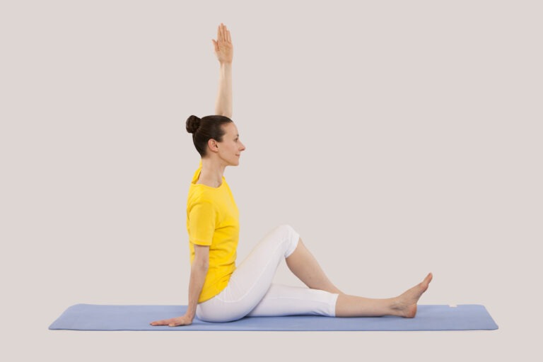Step 2 of Half Spinal Twist with extended leg
